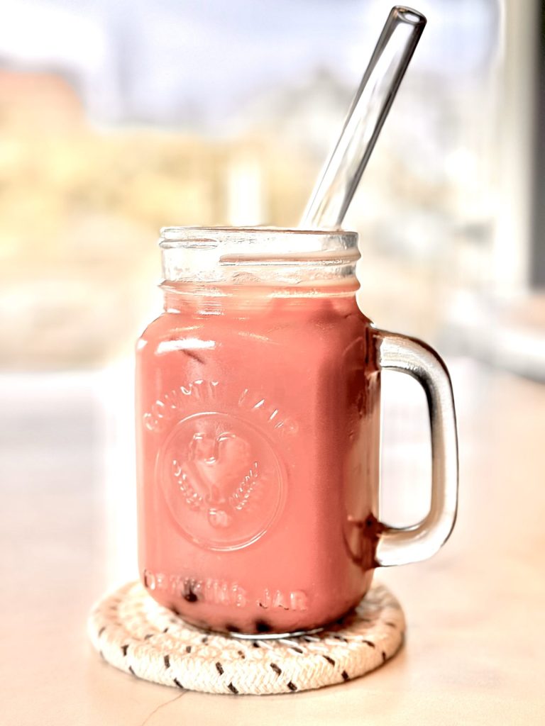 Strawberry boba drink in glass mason jar